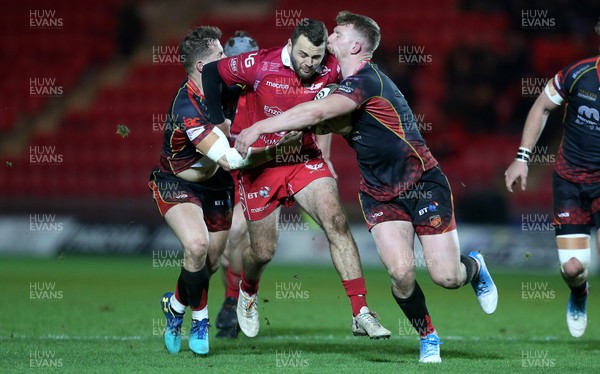 050119 - Scarlets v Dragons - Guinness PRO14 - Paul Asquith of Scarlets is tackled by Hallam Amos and Jack Dixon of Dragons