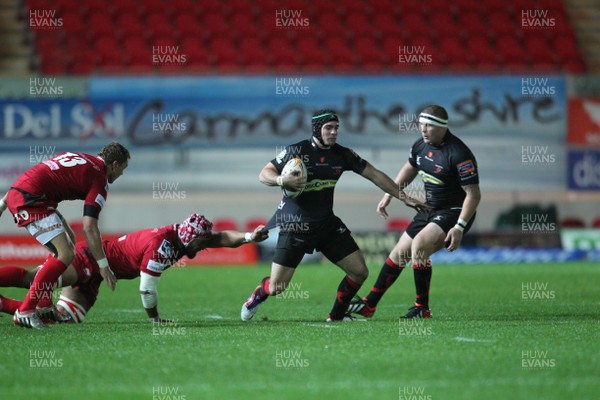 051012 Scarlets v DragonsDragon's Adam Hughes beats tackle by Sione Timani of Scarlets