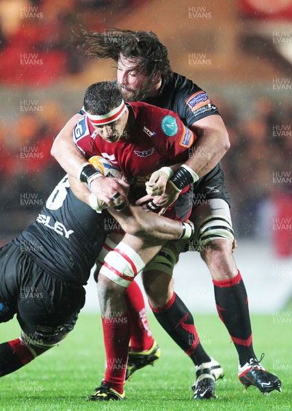 051012 Scarlets v DragonsAaron Shingler of Scarlets is tackled by Dragon's Ian Nimmo and Toby Faletau