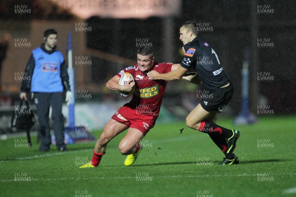 051012 Scarlets v Dragons- RaboDirect Pro12 - Scarlets' Tavis Knoyle is tackled by Dragons' Tom Prydie 