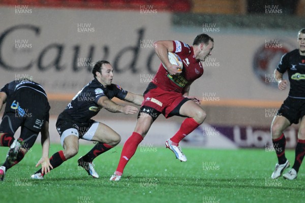 051012 Scarlets v Dragons- RaboDirect Pro12 - Scarlets' Morgan Stoddart avoids tackles from Dragons' Ashley Smith and Will Harries 