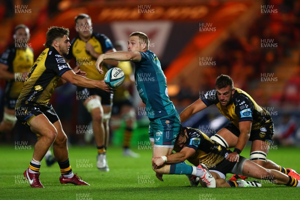 061023 - Scarlets v Dragons RFC - Preseason Friendly - Johnny McNicholl of Scarlets is tackled