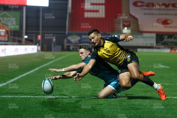 061023 - Scarlets v Dragons RFC - Preseason Friendly - Tomi Lewis of Scarlets scores a try under pressure from Sio Tomkinson of Dragons