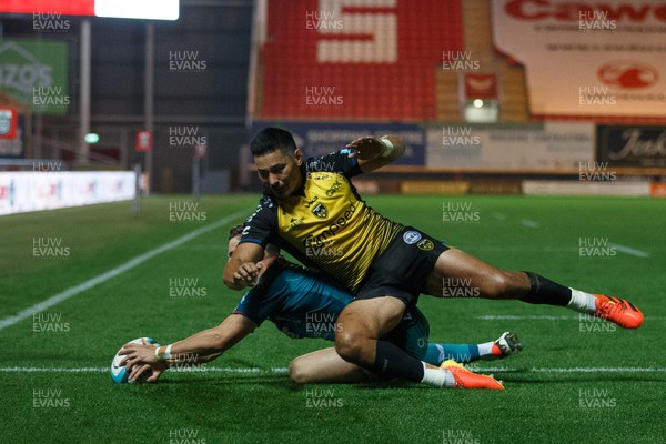 061023 - Scarlets v Dragons RFC - Preseason Friendly - Tomi Lewis of Scarlets scores a try under pressure from Sio Tomkinson of Dragons