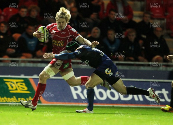 081113  - Scarlets v Newport Gwent Dragons - LV= Cup - Daniel Thomas of Scarlets is tackled by Kristopher Burton of Newport Gwent Dragons  