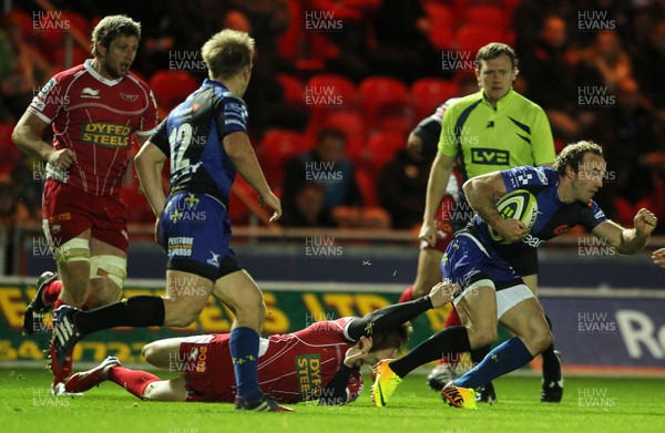 081113  - Scarlets v Newport Gwent Dragons - LV= Cup -  Will Harries of Newport Gwent Dragons is tackled by Kirby Myhill of Scarlets