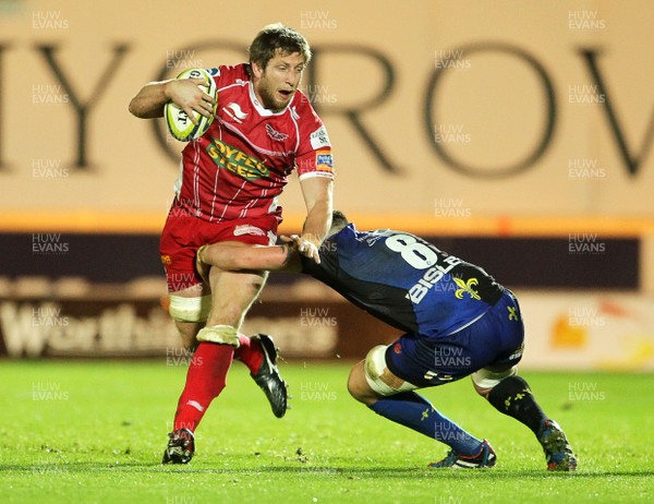 081113  - Scarlets v Newport Gwent Dragons - LV= Cup - Richard Kelly of Scarlets is tackled by Leuan Jones of Newport Gwent Dragons 