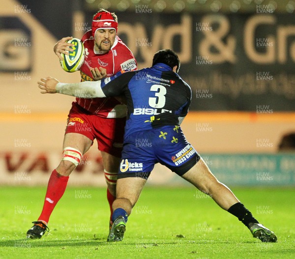 081113  - Scarlets v Newport Gwent Dragons - LV= Cup - Joe Snyman of Scarlets is tackled by Francisco Tetaz Chaparro of Newport Gwent Dragons  