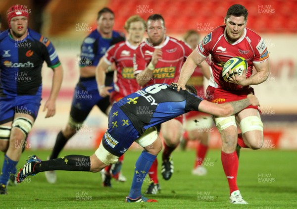 081113  - Scarlets v Newport Gwent Dragons - LV= Cup - Rob McCusker of Scarlets is tackled by Leuan Jones of Newport Gwent Dragons 