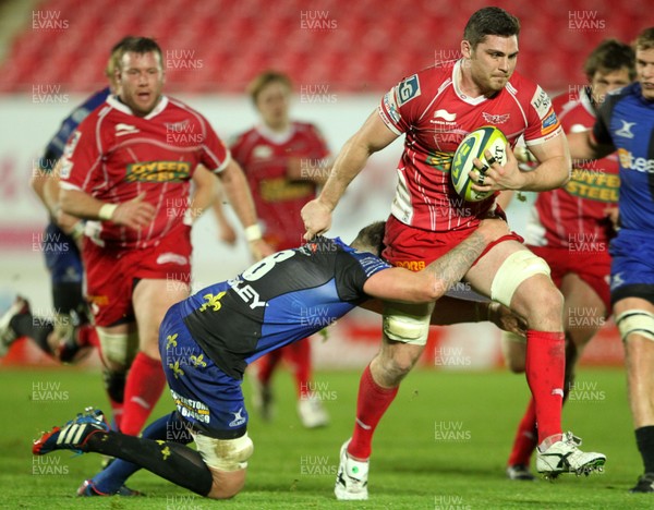 081113  - Scarlets v Newport Gwent Dragons - LV= Cup - Rob McCusker of Scarlets is tackled by Leuan Jones of Newport Gwent Dragons 