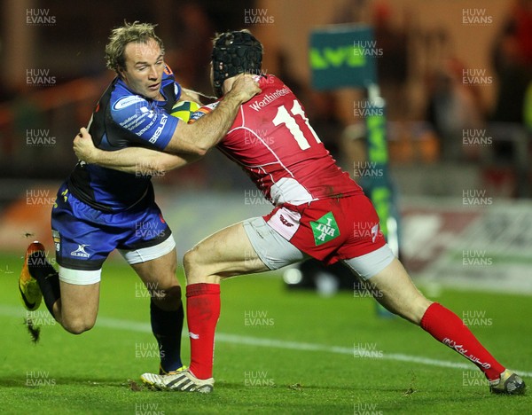 081113  - Scarlets v Newport Gwent Dragons - LV= Cup - Will Harries of Newport Gwent Dragons is tackled by Chris Knight of Scarlets 