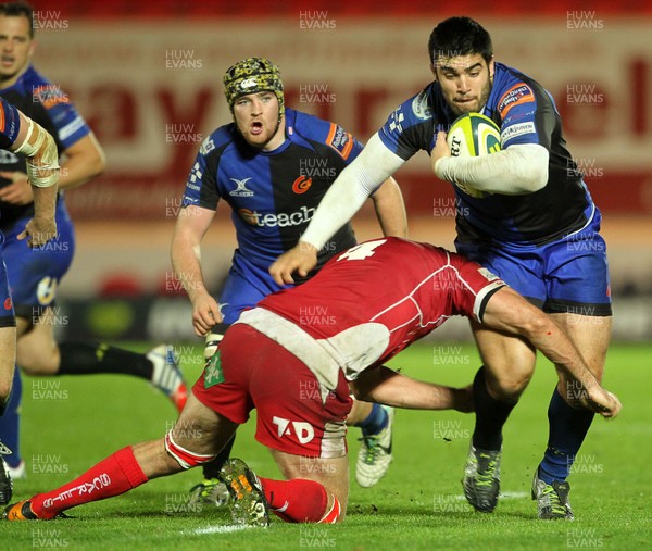 081113  - Scarlets v Newport Gwent Dragons - LV= Cup -  Francisco Tetaz Chaparro of Newport Gwent Dragons is tackled by Joe Snyman of Scarlets