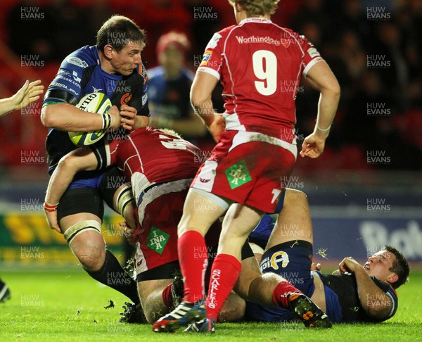 081113  - Scarlets v Newport Gwent Dragons - LV= Cup -  Adam Jones of Newport Gwent Dragons is tackled by Rhodri Jones of Scarlets