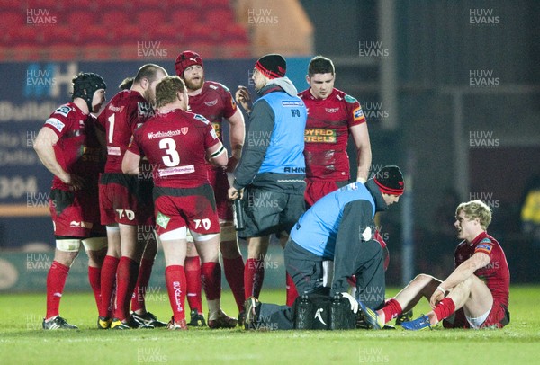 010313 - Scarlets v Edinburgh - RaboDirect PRO12 -Aled Davies of Scarlets, right, is seen to by the team physic after damaging his ankle 