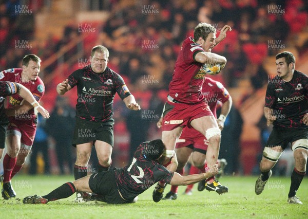 010313 - Scarlets v Edinburgh - RaboDirect PRO12 -Joe Synman of Scarlets, attempts to hurdle the tackle of Edinburgh's Ben Atiga 