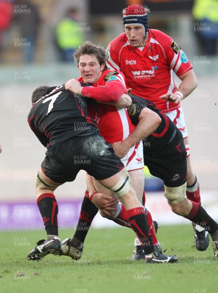 08.03.09 - Scarlets v Edinburgh, Magners League. -  Scarlets' Darren Daniel is stopped by Edinburgh's Alan Macdonald and Scott MacLeod  