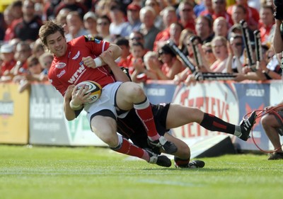 10.05.08 - Magners League Rugby Llanelli Scarlets v Edinburgh Scarlets' Gavin Evans is brought down 