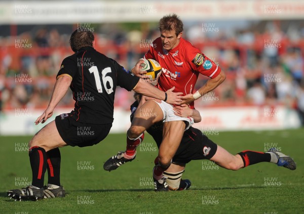 10.05.08 - Magners League Rugby Llanelli Scarlets v Edinburgh Scarlets' Dafydd James tries is tackled by Edinburgh's Steve Lawrie and Ben Cairns 