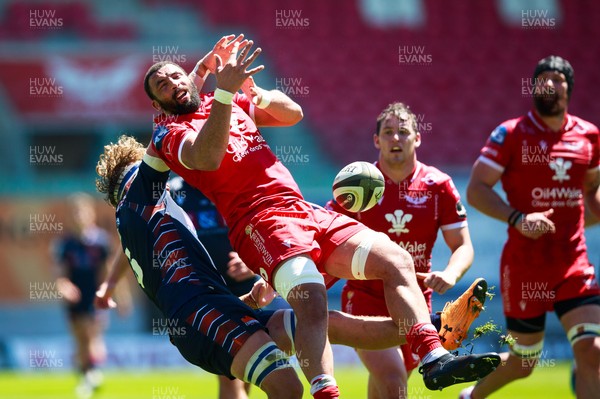 130621 - Scarlets v Edinburgh - Guinness PRO14 Rainbow Cup - Uzair Cassiem of Scarlets is tackled in the air by Jamie Ritchie of Edinburgh