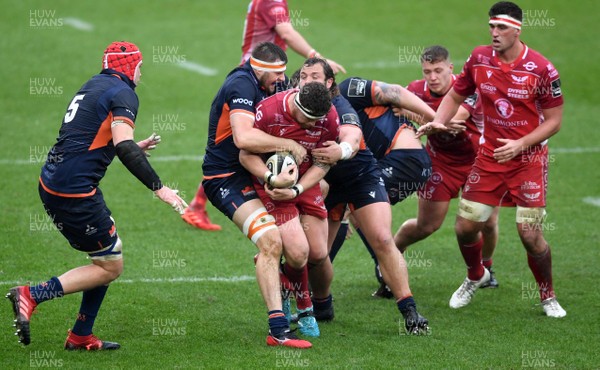 150220 - Scarlets v Edinburgh - Guinness PRO14 - Phil Price of Scarlets is tackled by Nick Haining and Pierre Schoeman of Edinburgh