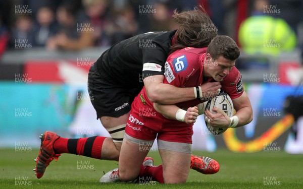 280315 - Scarlets v Edinburgh - Guinness PRO12 - Scott Williams of Scarlets is tackled by Ben Toolis of Edinburgh