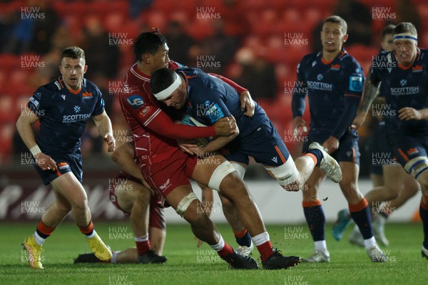 180223 - Scarlets v Edinburgh Rugby - United Rugby Championship - Marshall Sykes of Edinburgh is tackled by Sam Lousi of Scarlets