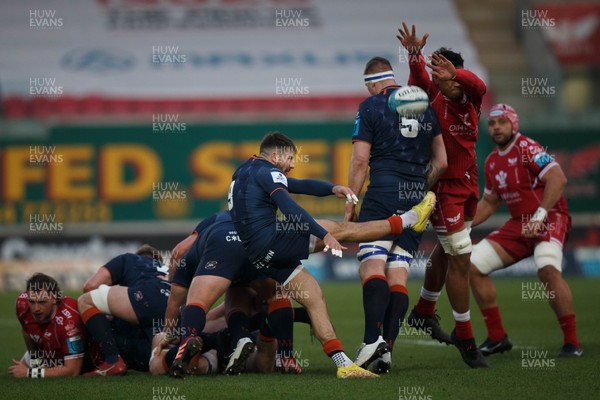 180223 - Scarlets v Edinburgh Rugby - United Rugby Championship - Charlie Shiel of Edinburgh kicks the ball as Sam Lousi of Scarlets attempts to charge it down