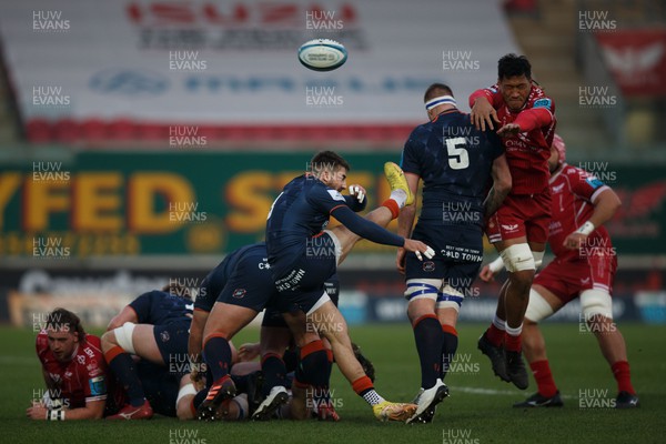 180223 - Scarlets v Edinburgh Rugby - United Rugby Championship - Charlie Shiel of Edinburgh kicks the ball as Sam Lousi of Scarlets attempts to charge it down