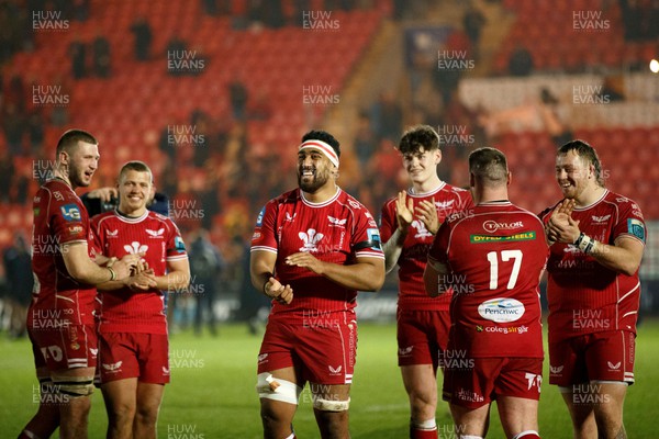 180223 - Scarlets v Edinburgh Rugby - United Rugby Championship - Carwyn Tuipulotu (centre) and other Scarlets players celebrate with the crowd after the match