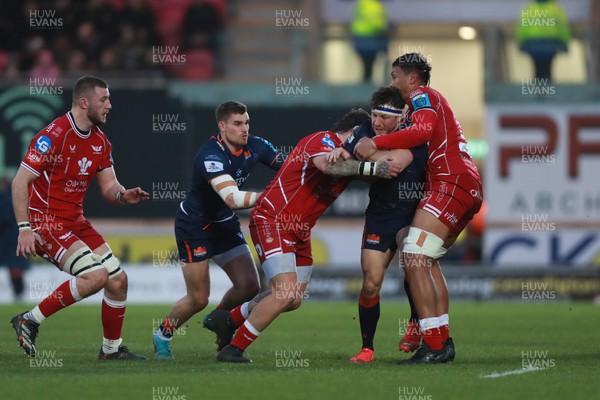 180223 - Scarlets v Edinburgh Rugby - United Rugby Championship - Dave Cherry of Edinburgh is stopped by Sam Lousi and Vaea Fifita  of Scarlets