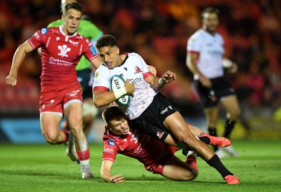 011021 - Scarlets v Emirates Lions - United Rugby Championship - Jordan Hendrikse of Lions is tackled by Sam Costelow of Scarlets