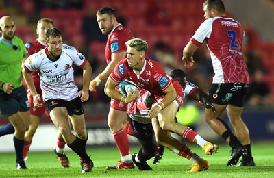 011021 - Scarlets v Emirates Lions - United Rugby Championship - Tom Rogers of Scarlets gets past Sti Sithole of Lions