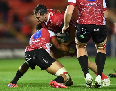 011021 - Scarlets v Emirates Lions - United Rugby Championship - Ryan Elias of Scarlets is tackled by Jordan Hendrikse of Lions