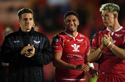 011021 - Scarlets v Emirates Lions - United Rugby Championship - Kieran Hardy, Dan Davis and Tom Rogers of Scarlets celebrate win