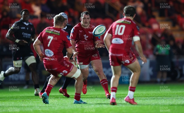 111123 - Scarlets v Emirates Lions, United Rugby Championship - Ryan Elias of Scarlets passes the ball to Ioan Lloyd of Scarlets
