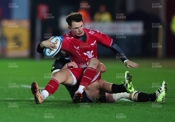 111123 - Scarlets v Emirates Lions, United Rugby Championship - Tom Rogers of Scarlets is tackled by Richard Kriel of Lions