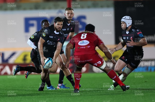 111123 - Scarlets v Emirates Lions, United Rugby Championship - Marius Louw of Lions takes on Carwyn Tuipulotu of Scarlets