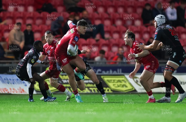 111123 - Scarlets v Emirates Lions, United Rugby Championship - Eddie James of Scarlets is tackled as he charges forward