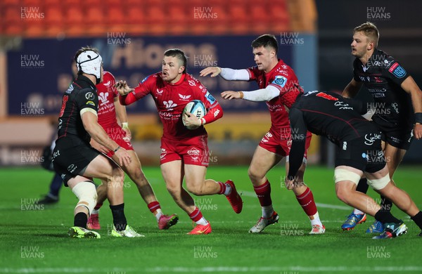111123 - Scarlets v Emirates Lions, United Rugby Championship - Steff Evans of Scarlets takes on Henco van Wyk of Lions