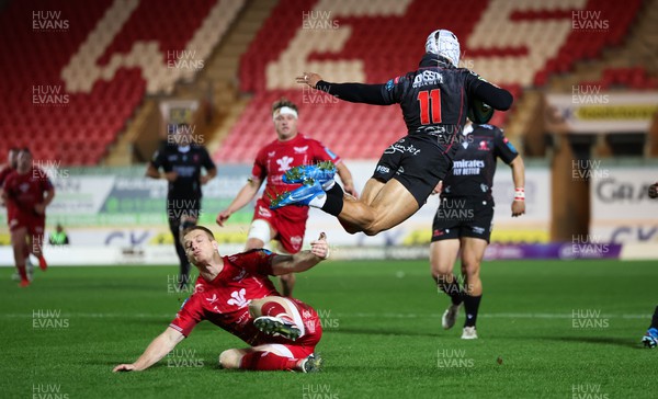 111123 - Scarlets v Emirates Lions, United Rugby Championship -Edwill van der Merwe of Lions is sent flying as Johnny McNicholl of Scarlets tackles