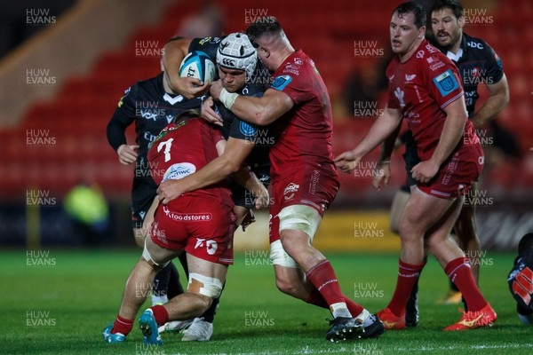 111123 - Scarlets v Emirates Lions - United Rugby Championship - Ruan Venter of Lions is tackled by Teddy Leatherbarrow and Alex Craig of Scarlets