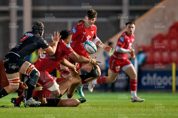 111123 - Scarlets v Emirates Lions - United Rugby Championship - Carwyn Tuipulotu of Scarlets offloads the ball to Eddie James