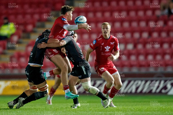 111123 - Scarlets v Emirates Lions - United Rugby Championship - Eddie James of Scarlets passes the ball to Johnny McNicholl