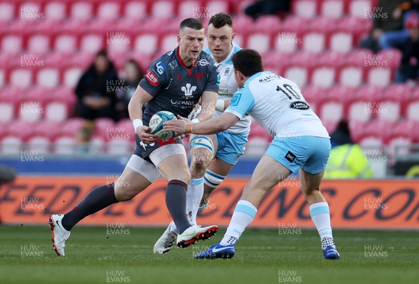 050322 - Scarlets v Glasgow - United Rugby Championship - Scott Williams of Scarlets is challenged by Duncan Weir of Glasgow