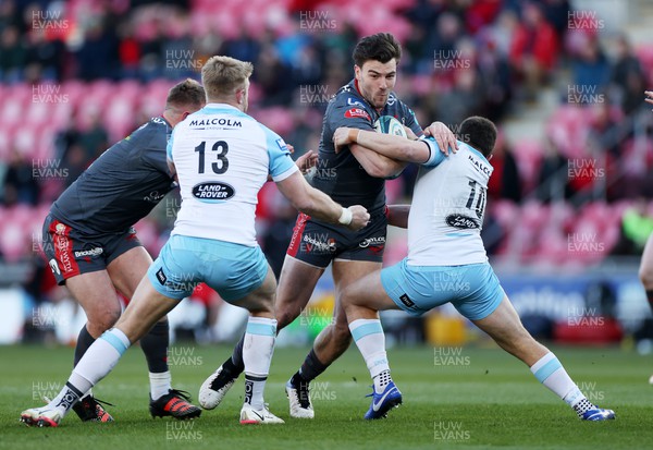 050322 - Scarlets v Glasgow - United Rugby Championship - Johnny Williams of Scarlets is tackled by Kyle Steyn and Duncan Weir of Glasgow