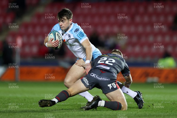 050322 - Scarlets v Glasgow - United Rugby Championship - Ross Thompson of Glasgow is tackled by Sam Costelow of Scarlets