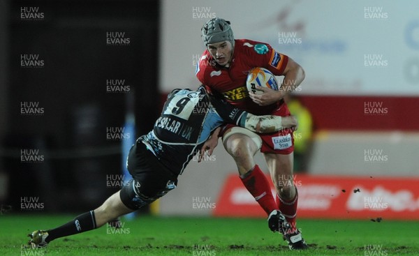 07.01.12 - Scarlets v Glasgow - RaboDirect PRO12 - Jonathan Davies of Scarlets is tackled by Henry Pyrgos of Glasgow. 