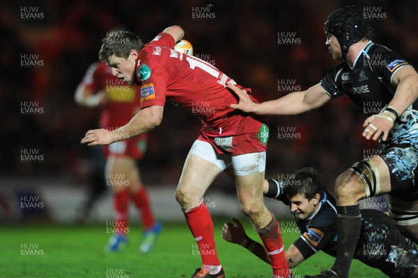 07.01.12 - Scarlets v Glasgow - RaboDirect PRO12 - Rhys Priestland of Scarlets is tackled by Peter Murchie (ground) and Rob Verbakel of Glasgow. 