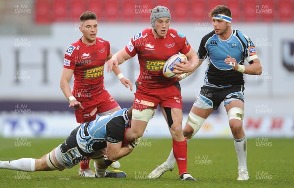 120413 - Scarlets v Glasgow Warriors - RaboDirect PRO12 -Jonathan Davies of Scarlets is tackled by Josh Strauss of Glasgow 