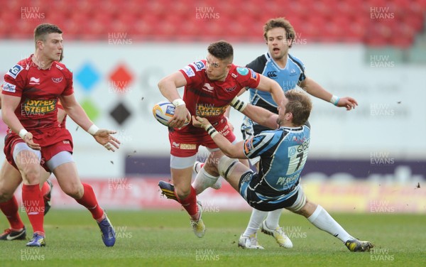 120413 - Scarlets v Glasgow Warriors - RaboDirect PRO12 -Owen Williams of Scarlets is tackled by John Barclay of Glasgow 